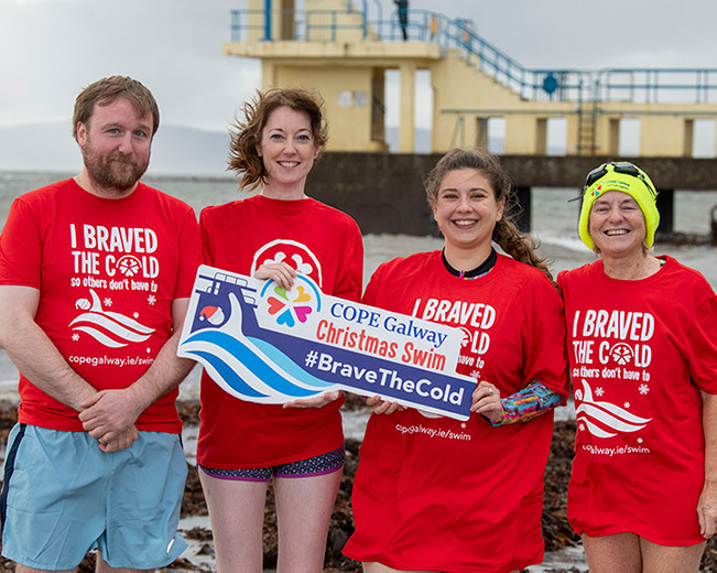 COPE Galway staff and volunteer launching 2022 Christmas Swim